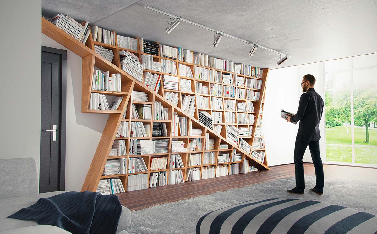 A person standing in front of a wall filled with books.