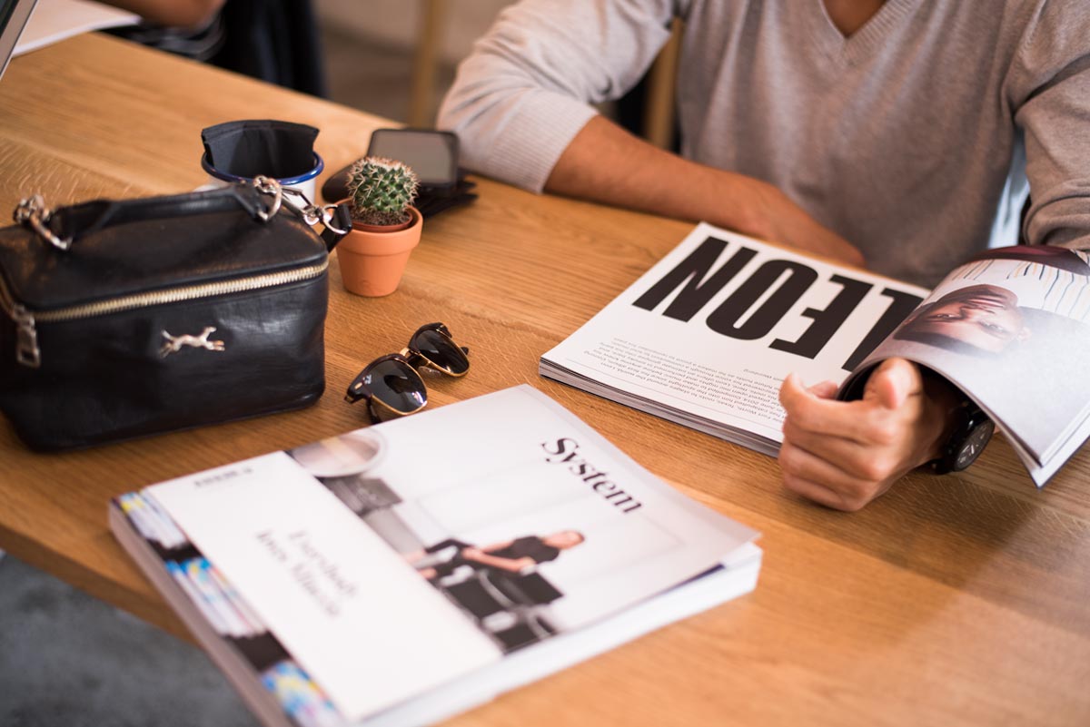 A man sitting at a table with some magazines